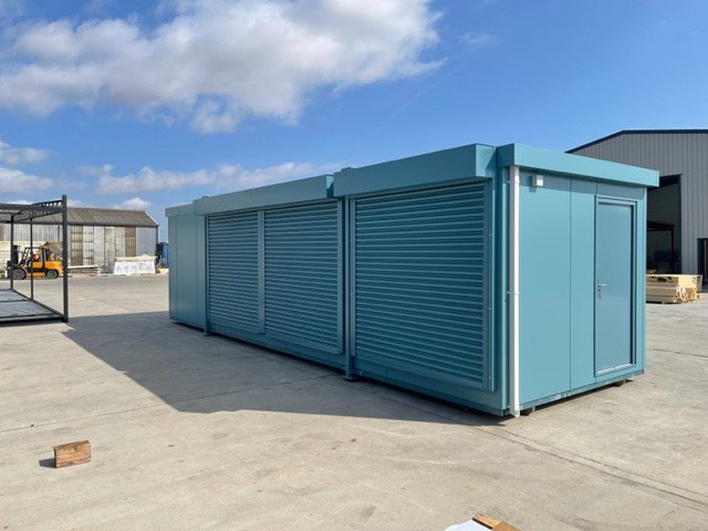 Blue portable buildings with shutters.